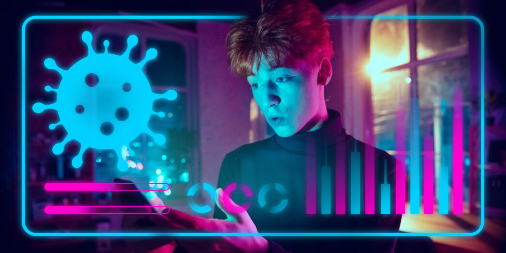 Young man interacting with a futuristic digital interface showing coronavirus data and statistics.